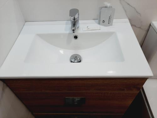 a bathroom sink with a white counter top at Hostal Carmen by gaiarooms in Salamanca