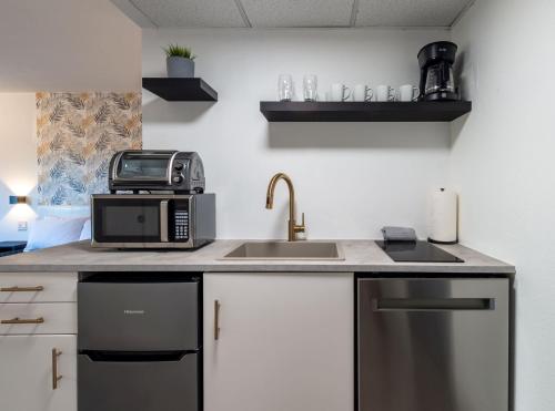 eine Küchentheke mit Mikrowelle und Spüle in der Unterkunft NEW - remodeled Studio close to Universal Studios in Orlando