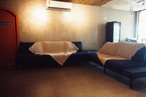 a living room with two blue couches in a room at Graffi Beach House in Florianópolis