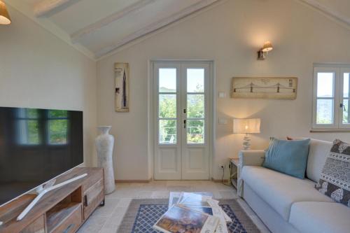 a living room with a couch and a table at I Giardini di Camogli - VILLA SÀRVIA, garden&pool in Camogli