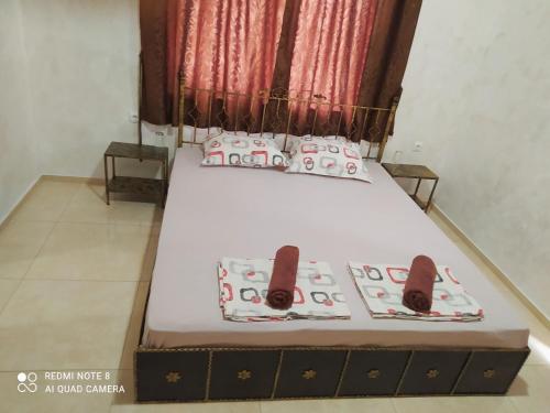 a bed in a room with two pillows on it at Dracena Guesthouse in Ravda
