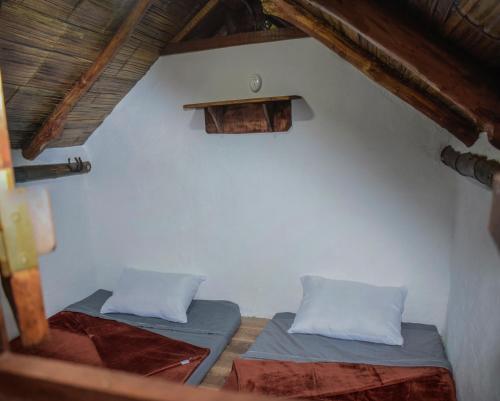 two beds in a room with a roof at Camping lagos de venecia in Santa Rosa de Cabal