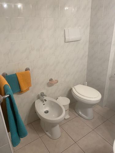 a white bathroom with a toilet and a bidet at belvedere acqua dolce 1 in Cala Gonone