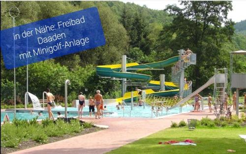 a water park with people playing in a pool at Ferienwohnung Fitness Entspannung Sauna im Westerwald in Derschen
