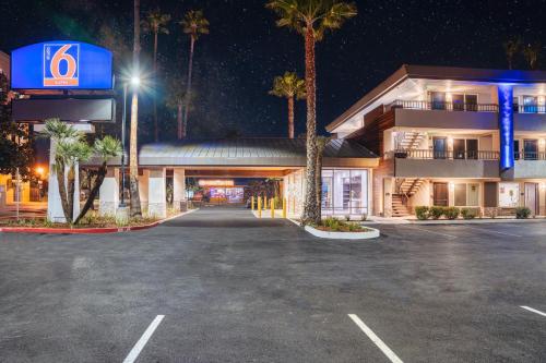 a parking lot in front of a hotel at night at Studio 6 Suites Stockton, CA Waterfront in Stockton