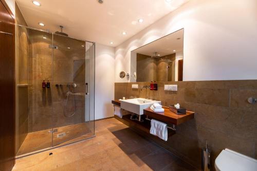 a bathroom with a sink and a shower at Neumühle Resort & Spa in Hammelburg