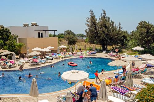 a group of people in a pool at a resort at Matina Pefkos Aparthotel in Pefki Rhodes
