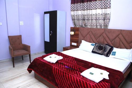 a bedroom with a bed with two towels on it at Quinte Hills Residency in Panchgani