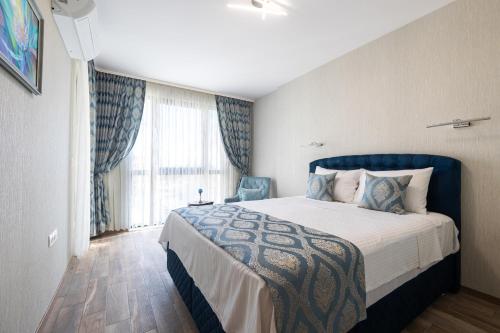 a hotel room with a bed and a window at Helena Holiday B in Saints Constantine and Helena