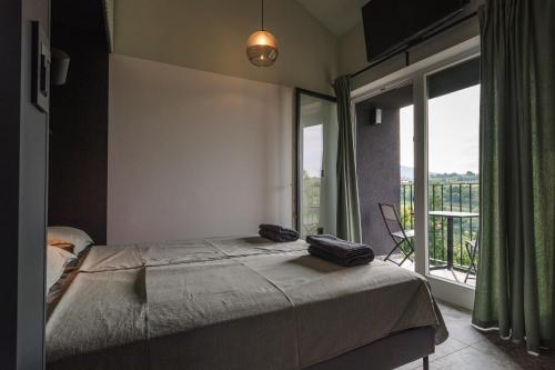a bedroom with a bed and a large window at Glamping Senesalina in Kojsko