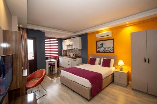 a bedroom with a large bed and a kitchen at Istanbul Taksim MARİDA SUIT in Istanbul