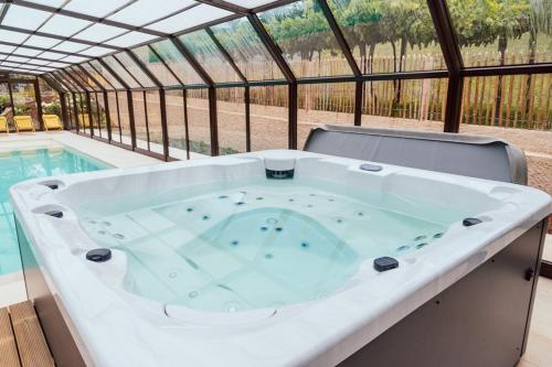 a large bath tub sitting next to a swimming pool at CASA CON ENCANTO (o Refuxio) in Merza