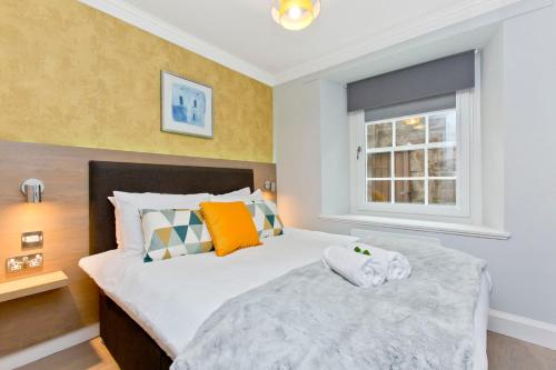 a bedroom with a large bed and a window at Ultra Modern, West End Village, Refurbished basement appt in Edinburgh