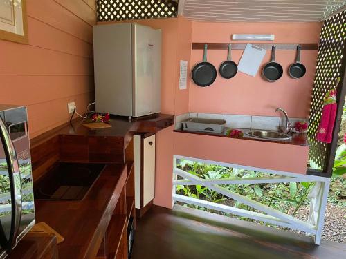 a small kitchen with a sink and a refrigerator at BORA BORA HOLIDAY'S LODGE in Bora Bora