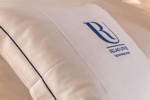 a close up of a white shirt with the letter r on it at Relais Uffizi in Florence