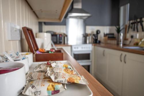 a kitchen with a table with a plate of food on it at The Old Post House in Kyle of Lochalsh