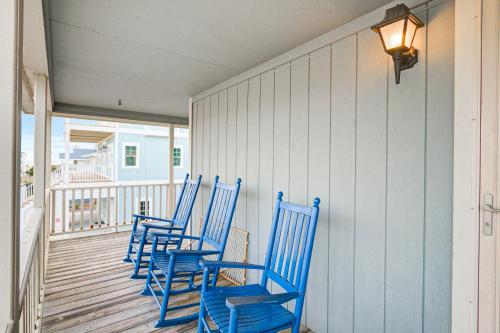 a row of blue chairs sitting on a porch at The Owen-ly Place to Be in Holden Beach