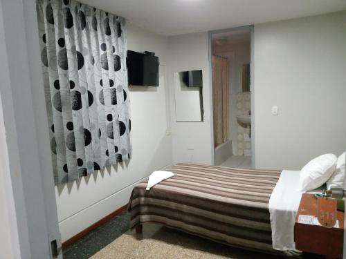 Säng eller sängar i ett rum på Hotel Plazza