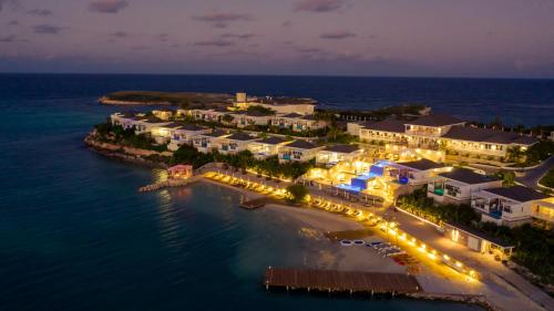 an aerial view of a resort in the ocean at night at Hammock Cove Antigua - All Inclusive - Adults Only in Willikies