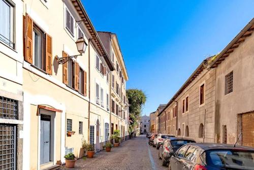 a narrow street with cars parked on the sides of buildings at La maison b8 in Rome