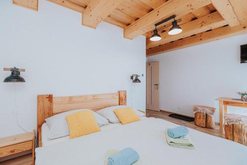 a bedroom with a bed with two towels on it at Penzión Natália in Terchová