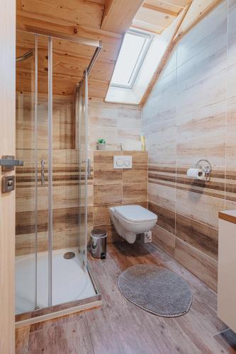 a bathroom with a toilet and a glass shower at Penzión Natália in Terchová