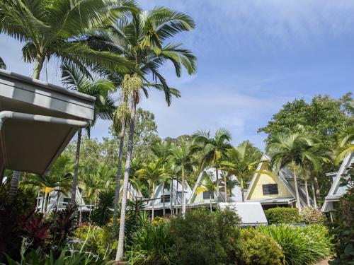 a view of a resort with palm trees at Canopy 5 Chalet in Nelly Bay