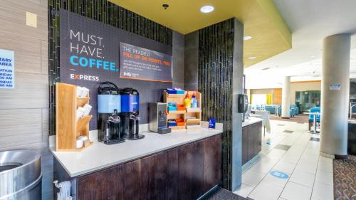 a coffee shop with a counter with a must have coffee sign at Holiday Inn Express Boise Downtown by IHG in Boise
