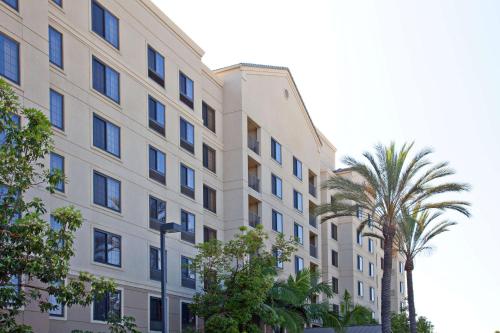a building with palm trees in front of it at Sonesta ES Suites Anaheim Resort Area in Anaheim