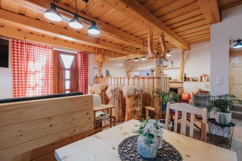 a room with wooden ceilings and a table and chairs at Penzión Natália in Terchová