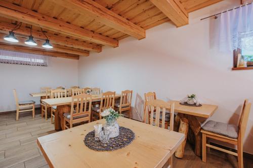 a dining room with wooden tables and chairs at Penzión Natália in Terchová