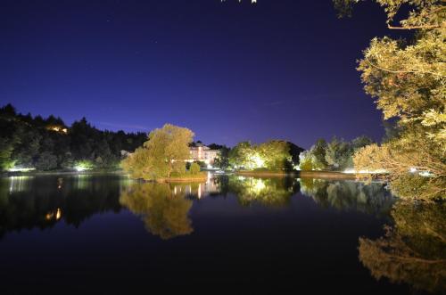 a view of a lake at night at Parco del Lago Resort & SPA in Villagrande