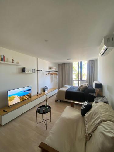 a bedroom with a bed and a tv in it at Estudio Loft in Mar del Plata