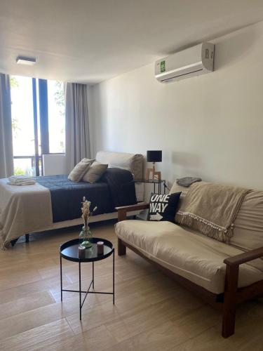 a living room with a bed and a couch at Estudio Loft in Mar del Plata