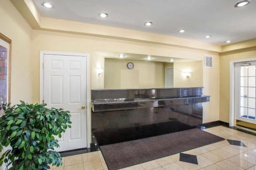 a large bathroom with a sink and a mirror at Atlantic Inn in Pleasantville