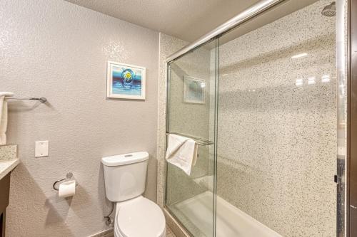 a bathroom with a toilet and a glass shower at Amanzi Hotel, an Ascend Collection Hotel in Ventura