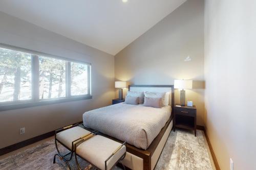a bedroom with a large bed and a window at Red Sky Luxury Retreat in Wolcott