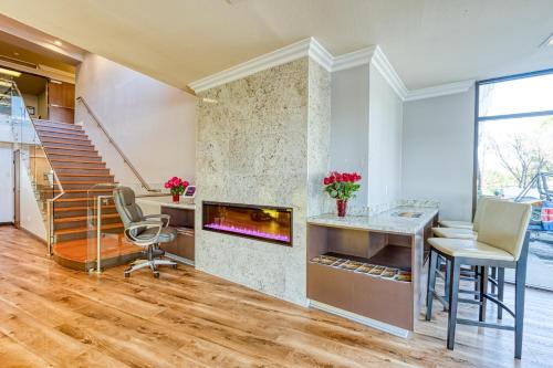 a living room with a fireplace and a desk and chairs at Amanzi Hotel, an Ascend Collection Hotel in Ventura