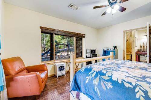 a bedroom with a bed and a chair and a window at The Cub Inn in Groveland