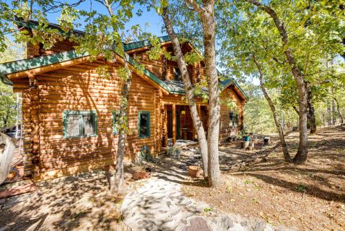 a log cabin with trees in front of it at The Cub Inn in Groveland