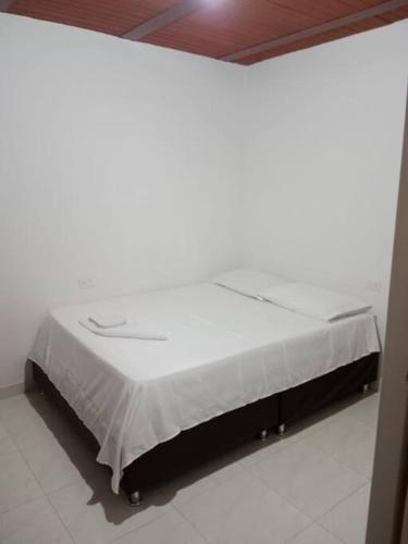 a large white bed in a room with at Hospedaje El Cerrito 2 in El Cerrito
