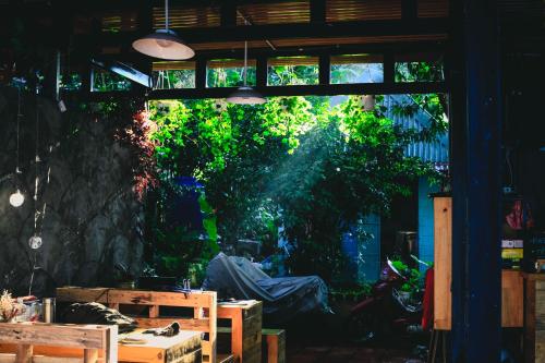 a room with a large window with a tree outside at The Lake House Dalat in Da Lat