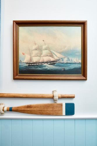 a painting of a ship in the water with a baseball bat at The Clovelly Hotel in Sydney