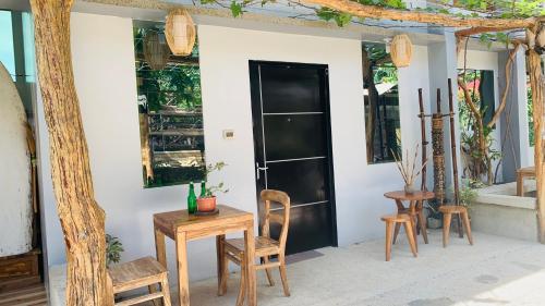 a room with a table and chairs and a door at Hidden of Cailan Family Room in El Nido