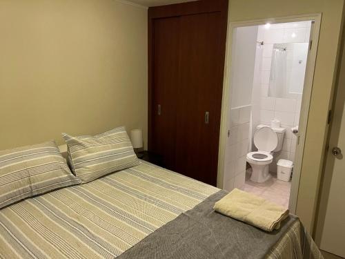- une chambre avec un lit et une salle de bains avec des toilettes dans l'établissement Apart hotel Chillan - Full house - Ohiggins - Empresas- Factura - Parking, à Chillán
