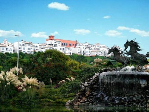 a statue of horses in front of a water fountain at Real del Mar Golf Resort in Tijuana