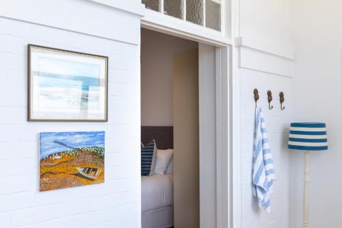 a hallway with a door leading to a bedroom at The Clovelly Hotel in Sydney