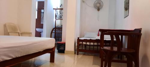 a bedroom with a bed and a table and chairs at Polhena Coral Reef Resort in Matara