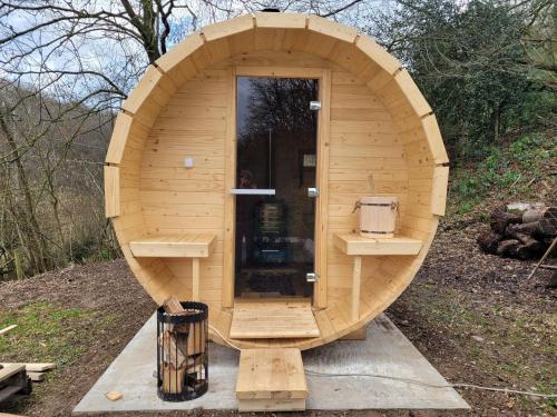 a small wooden sauna with a door in the middle at Holiday home with sauna and swimming pool in Verviers