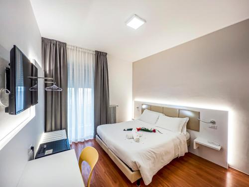 a hotel room with a bed and a television at Hotel Gran Sasso & SPA in Teramo